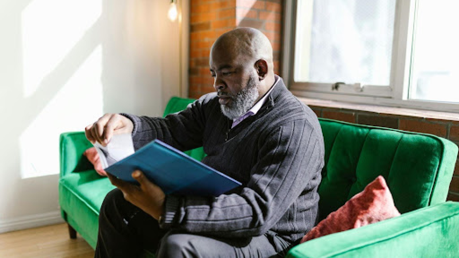 Man reviewing financial documents, representing the importance of accurate bookkeeping services for business management.