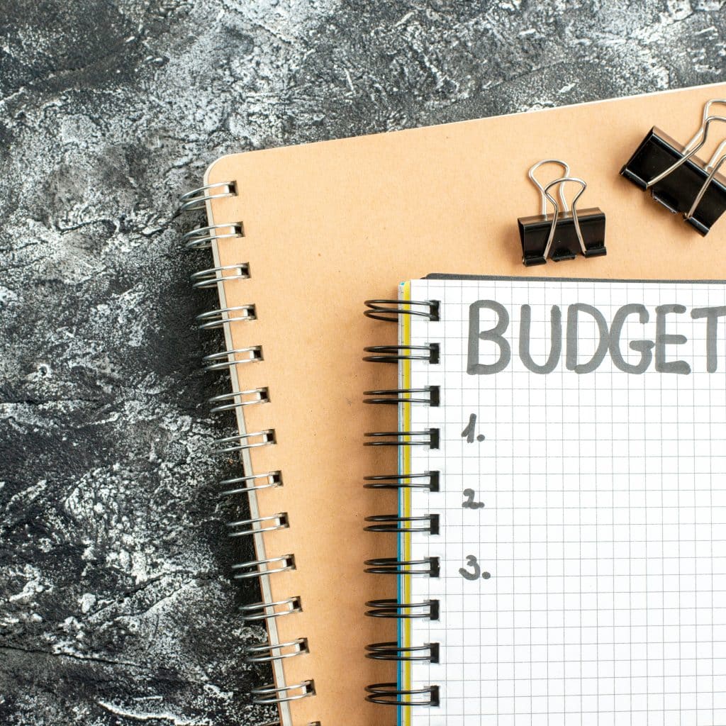 Notebook labeled 'Budget' on a desk, capturing the focus and intention behind effective payroll processing and financial planning.